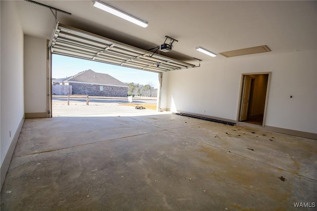 garage with a garage door opener and baseboards