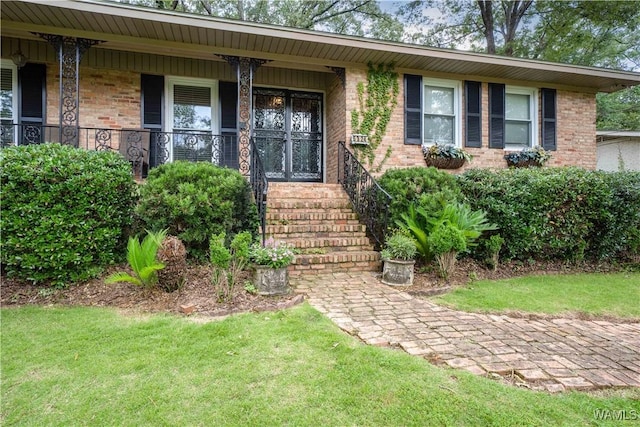 5324 Northwood Lake Dr W, Northport, AL 35473 - property entrance with brick siding, a porch, and a yard