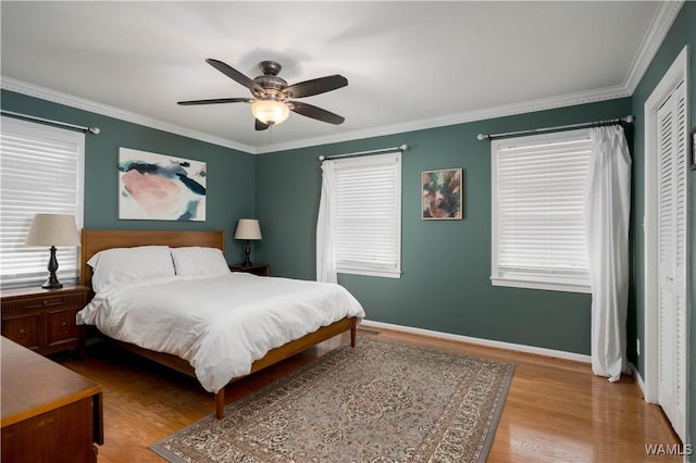 5324 Northwood Lake Dr W, Northport, AL 35473 - bedroom with wood finished floors, crown molding, a closet, and ceiling fan