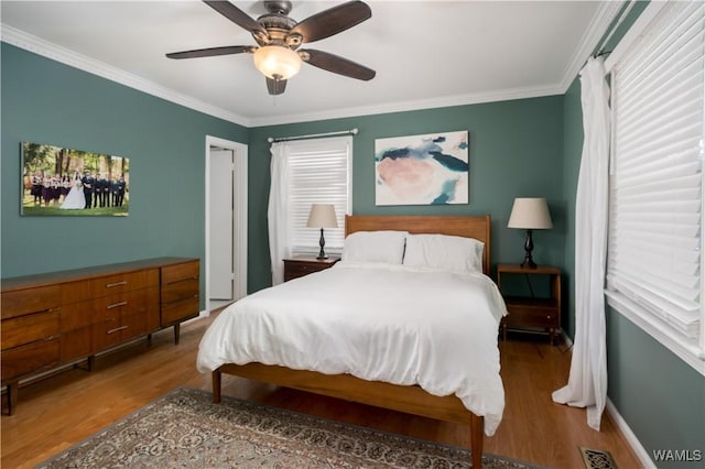 5324 Northwood Lake Dr W, Northport, AL 35473 - bedroom with wood finished floors, multiple windows, ornamental molding, and ceiling fan
