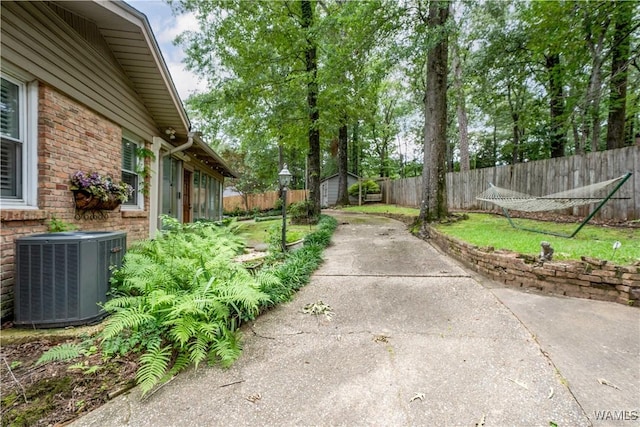 5324 Northwood Lake Dr W, Northport, AL 35473 - fenced backyard featuring a shed, a patio area, and concrete driveway