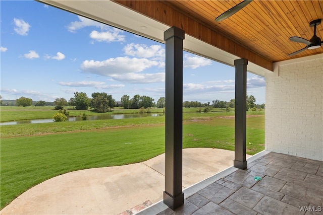 view of patio featuring ceiling fan and a water view