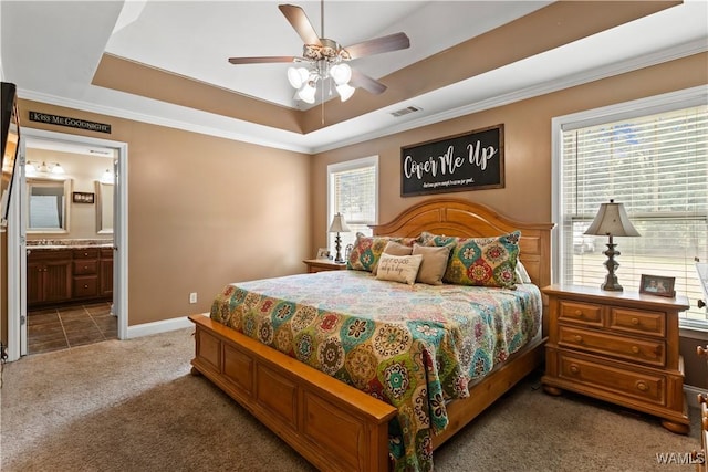 bedroom featuring crown molding, ceiling fan, connected bathroom, carpet floors, and a raised ceiling