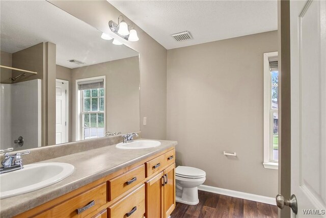 7714 Thompsons Way, Northport, AL 35473 - full bathroom featuring double vanity, wood finished floors, and a shower
