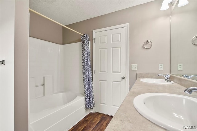 7714 Thompsons Way, Northport, AL 35473 - bathroom featuring shower / bath combination with curtain, wood finished floors, a textured ceiling, and double vanity