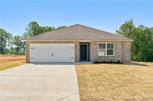 single story home with a garage and a front lawn