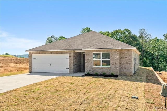 ranch-style home featuring a garage and a front yard