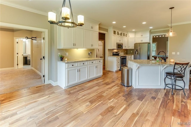 10998 Sleepy Valley Rd, Northport, AL 35475 - kitchen featuring appliances with stainless steel finishes, ornamental molding, a sink, white cabinetry, and light wood-type flooring