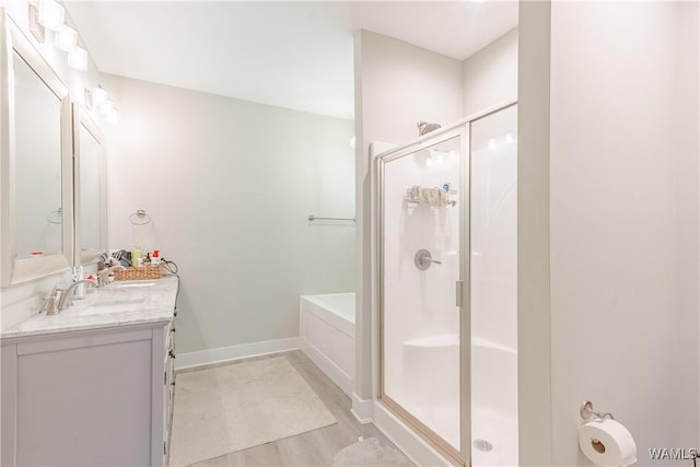 16471 Chase Cir, Ralph, AL 35480 - bathroom featuring a shower stall, vanity, baseboards, wood finished floors, and a garden tub
