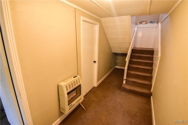 hall featuring heating unit, stairway, baseboards, and dark carpet