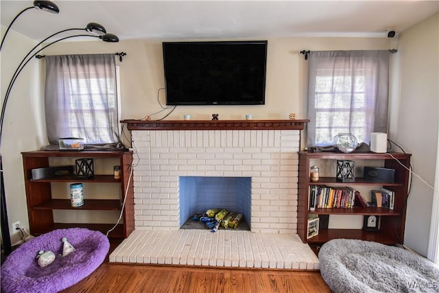 living room with a fireplace and wood finished floors