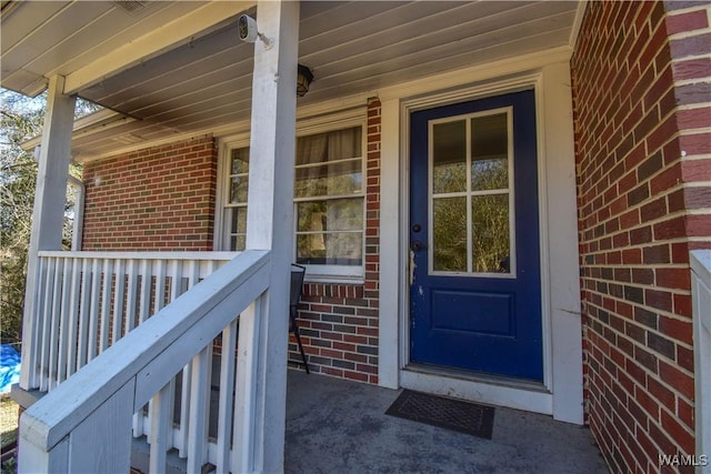 entrance to property with brick siding