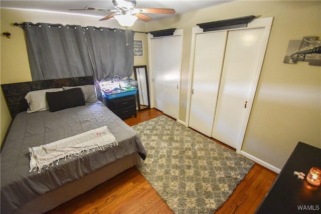 bedroom with wood finished floors, a ceiling fan, and baseboards