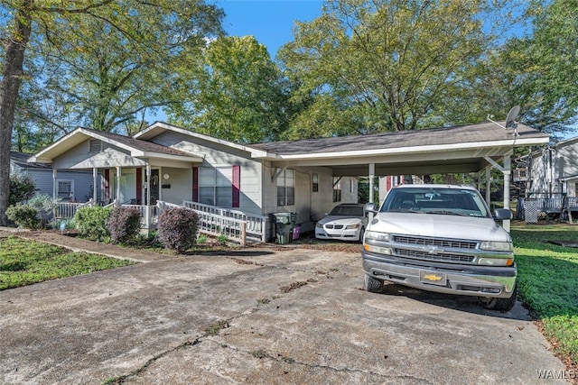 view of front of house featuring covered porch and a carport