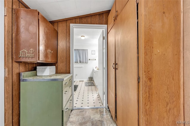 bathroom featuring wooden walls and lofted ceiling