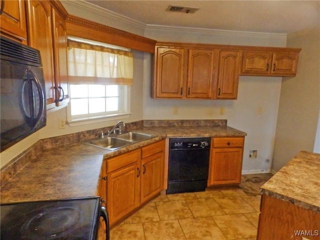 kitchen featuring brown cabinetry, visible vents, a sink, and black appliances