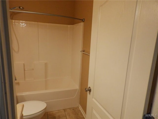 bathroom with bathtub / shower combination, tile patterned flooring, and toilet