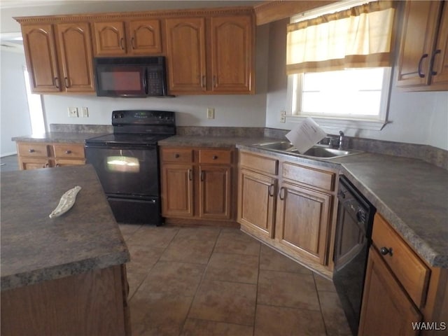 kitchen featuring light tile patterned floors, black appliances, and sink