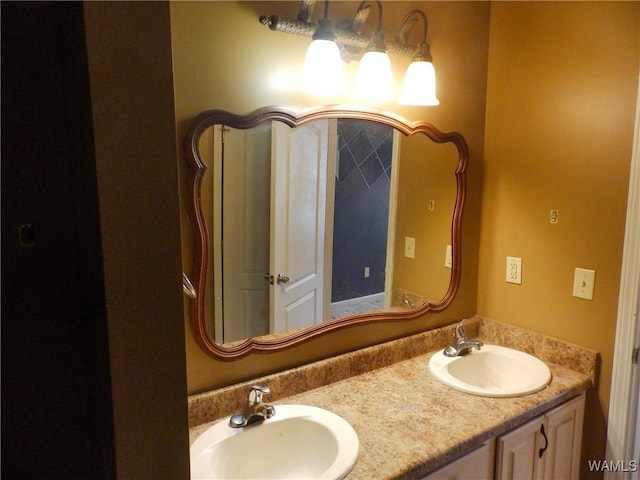 full bathroom with a sink and double vanity