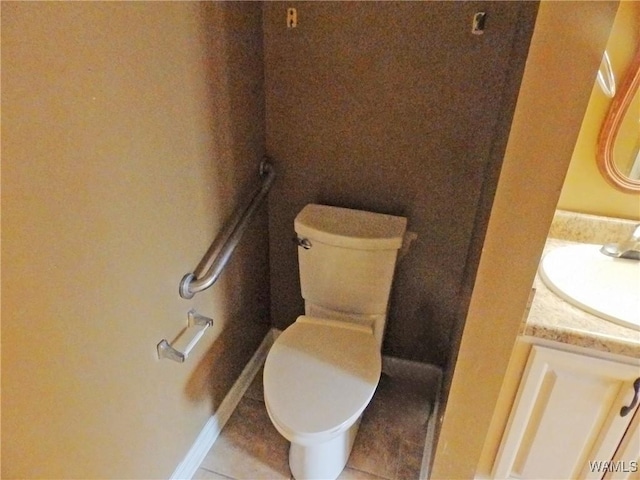 bathroom featuring toilet, tile patterned flooring, and vanity