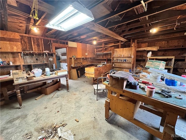 miscellaneous room with concrete flooring and a workshop area