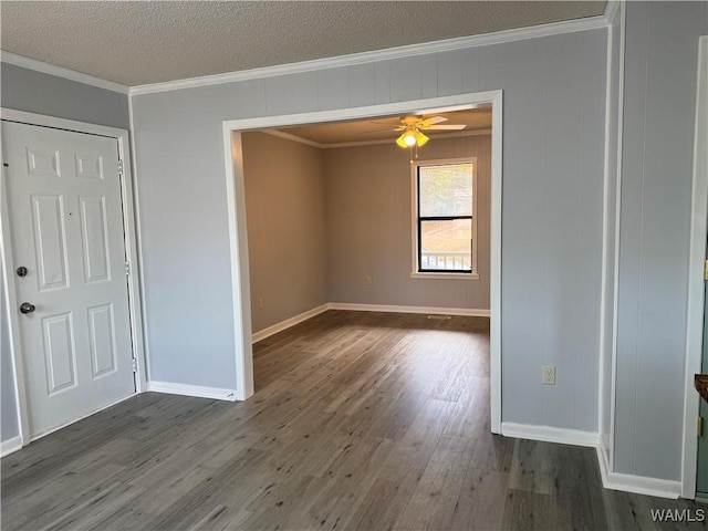 unfurnished room with a textured ceiling, crown molding, ceiling fan, and dark hardwood / wood-style floors