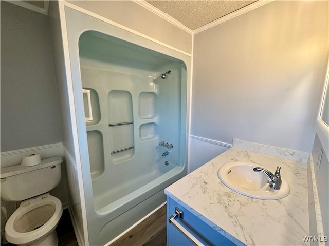 full bathroom featuring ornamental molding, vanity, a textured ceiling, shower / bathing tub combination, and toilet