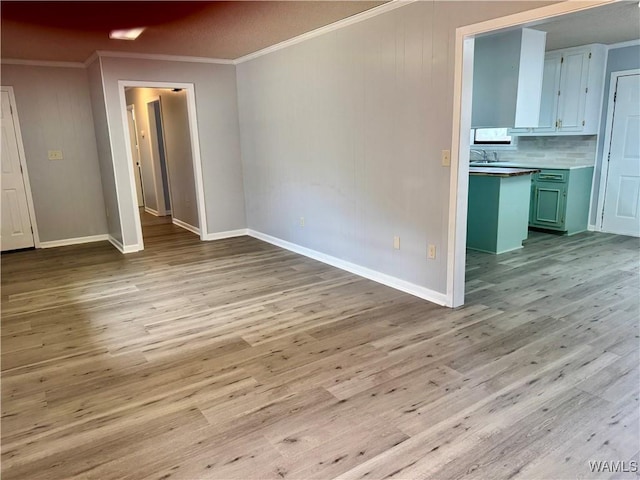 interior space featuring crown molding and light hardwood / wood-style floors