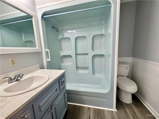 full bathroom with hardwood / wood-style floors, vanity, toilet, and shower / tub combination