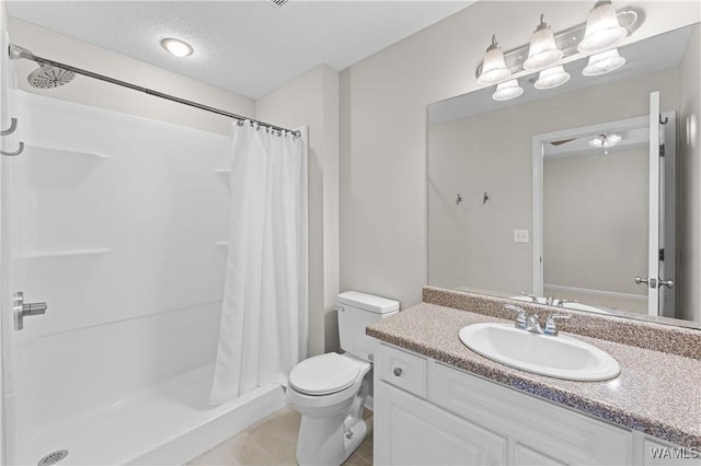 full bath with tile patterned floors, toilet, a stall shower, and vanity