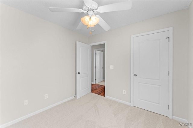 unfurnished bedroom featuring ceiling fan, carpet flooring, and baseboards