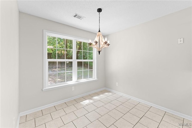 unfurnished room with a chandelier, light tile patterned flooring, baseboards, and visible vents