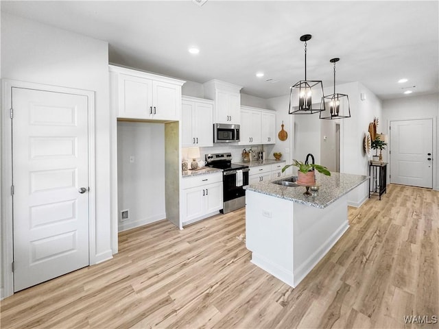 kitchen with stainless steel appliances, light wood finished floors, and white cabinets