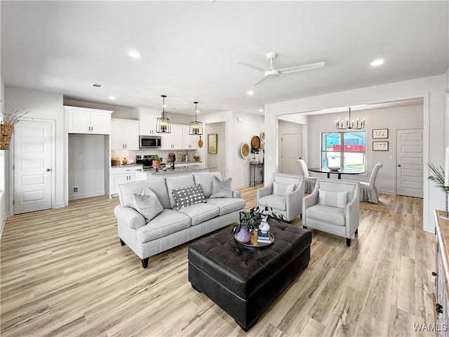 living room featuring visible vents, recessed lighting, and light wood-style floors