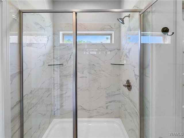 bathroom with a marble finish shower