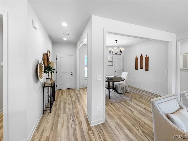 entrance foyer featuring light wood-type flooring, baseboards, a chandelier, recessed lighting, and visible vents