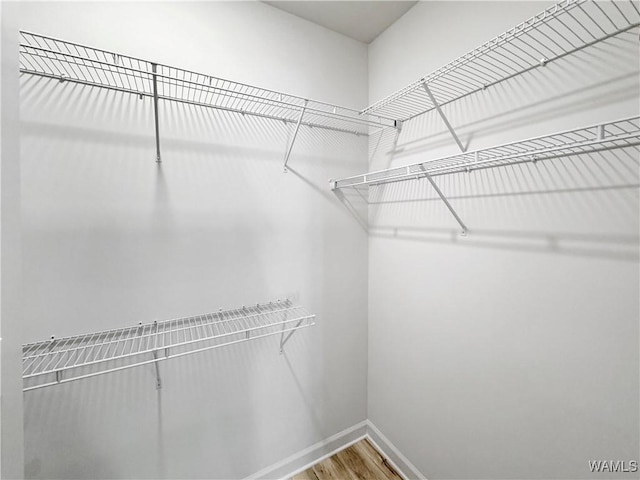 spacious closet with wood finished floors