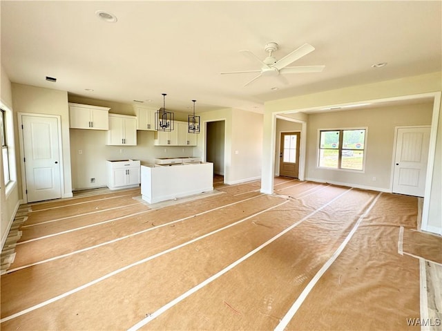11700 Cripple Creek Rd, Berry, AL 35546 - kitchen featuring white cabinets, a ceiling fan, baseboards, and open floor plan