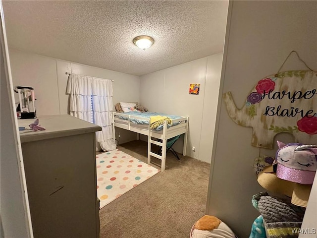 bedroom with carpet flooring and a textured ceiling