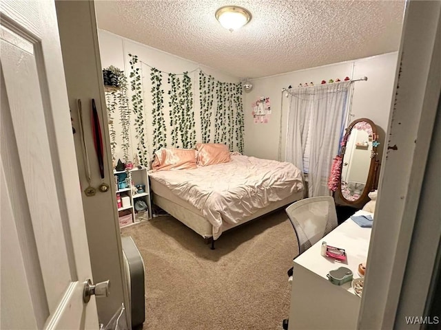 bedroom featuring carpet floors and a textured ceiling