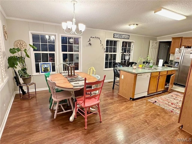 kitchen with decorative light fixtures, a center island, stainless steel fridge with ice dispenser, white dishwasher, and light hardwood / wood-style floors