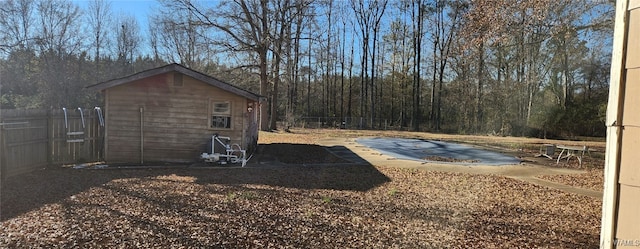 view of yard featuring a shed, a patio, and a covered pool