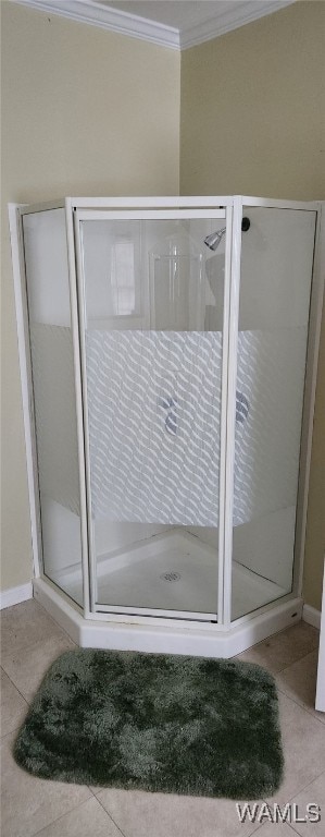 bathroom with an enclosed shower, crown molding, and tile patterned floors