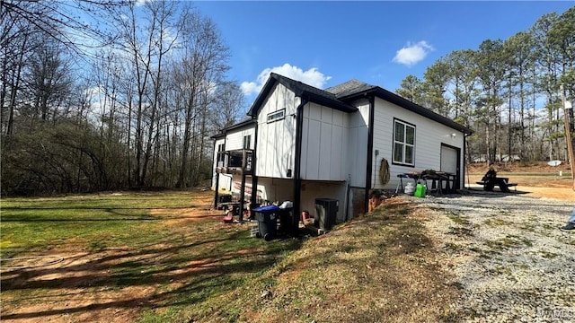 view of home's exterior with a yard, driveway, and an attached garage