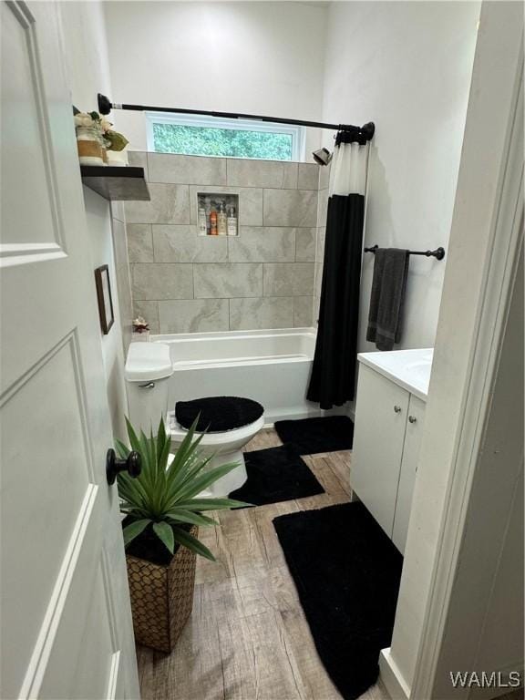 bathroom with shower / tub combo, vanity, toilet, and wood finished floors