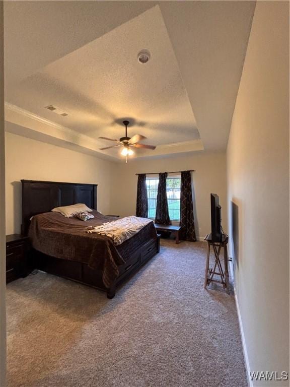 5203 Bristolwood Cir, Northport, AL 35475 - carpeted bedroom featuring a tray ceiling, a textured ceiling, and ceiling fan