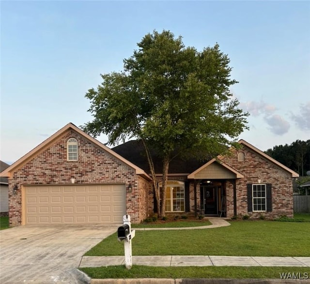 5203 Bristolwood Cir, Northport, AL 35475 - single story home with a front yard, concrete driveway, an attached garage, and brick siding