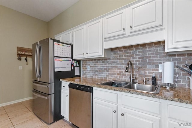 kitchen featuring white cabinetry, tasteful backsplash, appliances with stainless steel finishes, and a sink