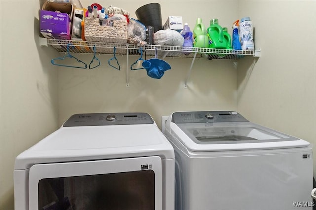 clothes washing area with washer and dryer and laundry area