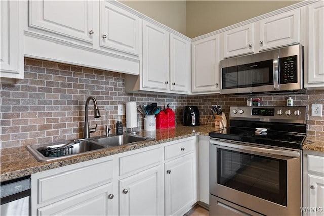 kitchen with tasteful backsplash, white cabinetry, stainless steel appliances, and a sink